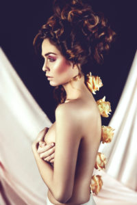 Fashion, beauty, view to the side, roses along the spine, fine light Fashion, beauty, view to the side, roses along the spine, fine light